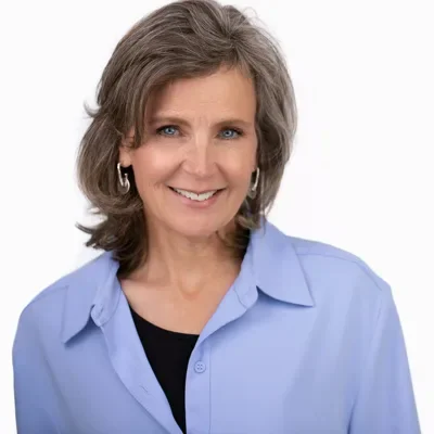LinkedIn headshot example — Portland studio (warm smile, light blue shirt)