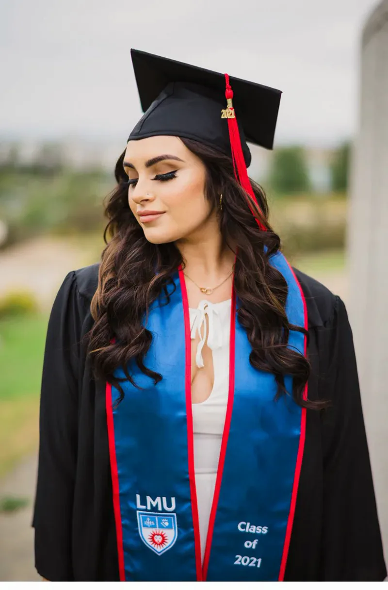 LMU graduation portrait in full cap and gown