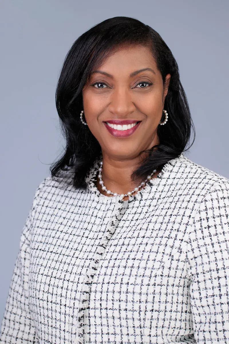 Warm professional headshot of a woman against a light studio background