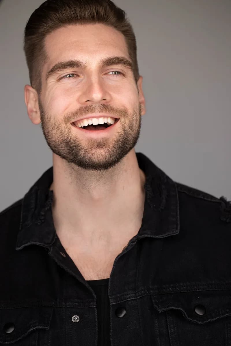 Professional headshot in business attire with clean studio lighting