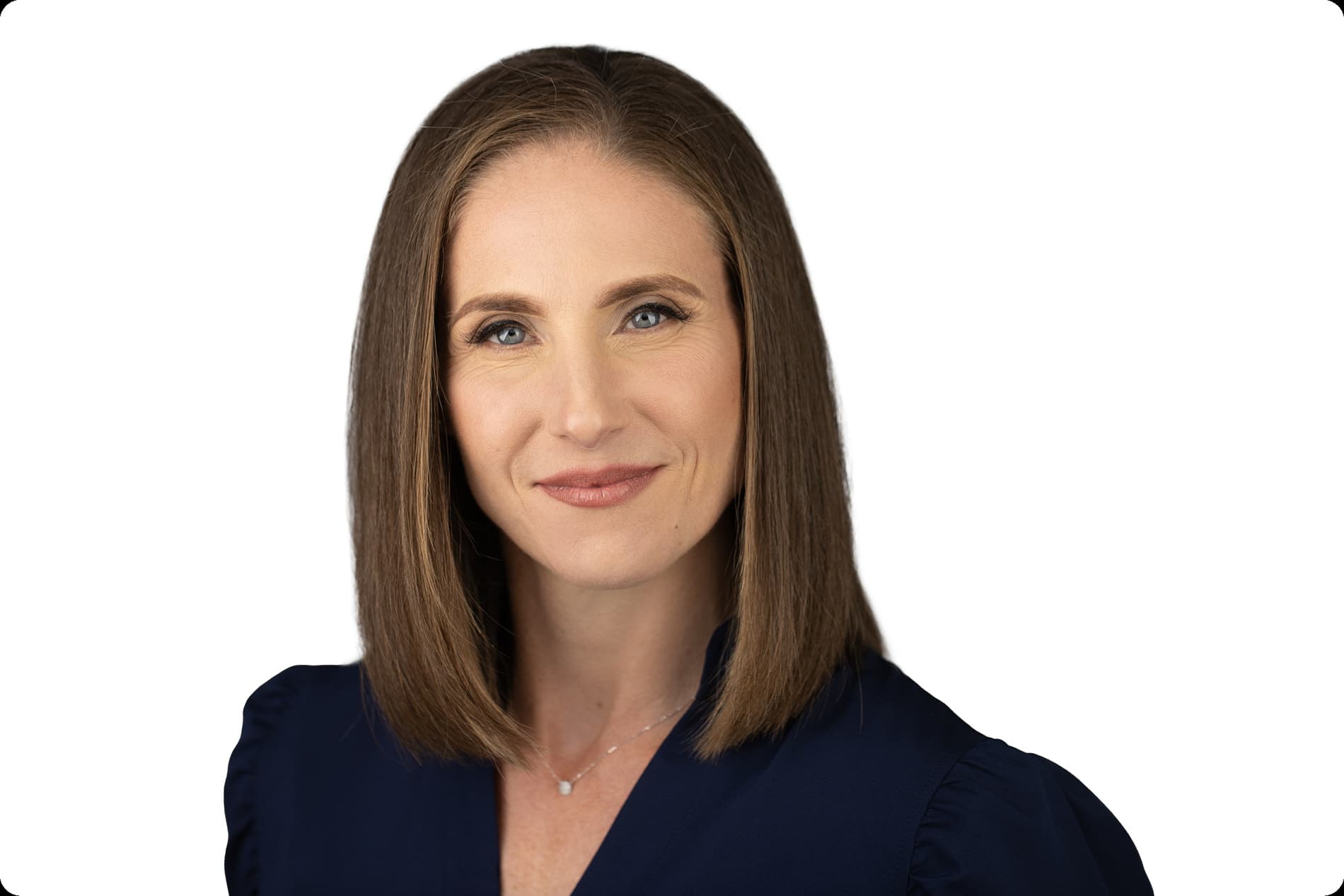 Professional headshot of woman with shoulder-length brown hair in navy blue top against white background