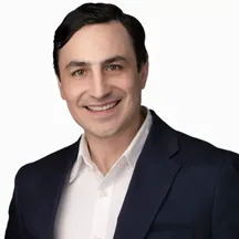 Professional headshot of man in navy suit