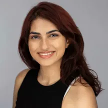 Professional headshot of woman with reddish-brown hair