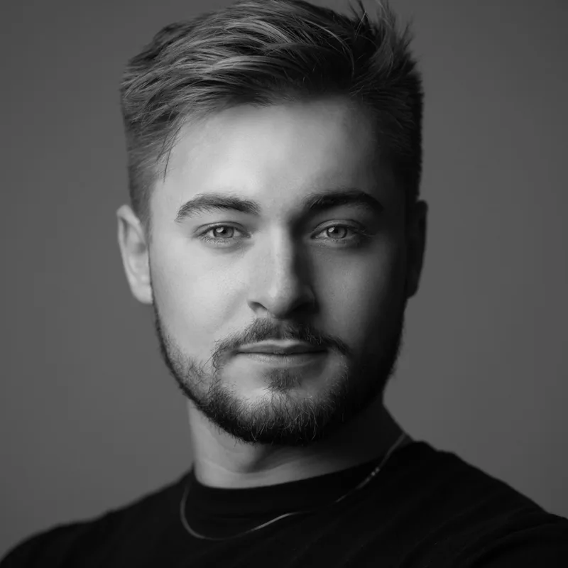 Professional closeup headshot of young man with beard