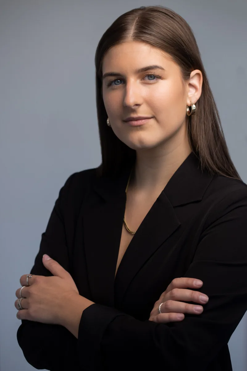 Professional headshot of woman with brown hair in blazer